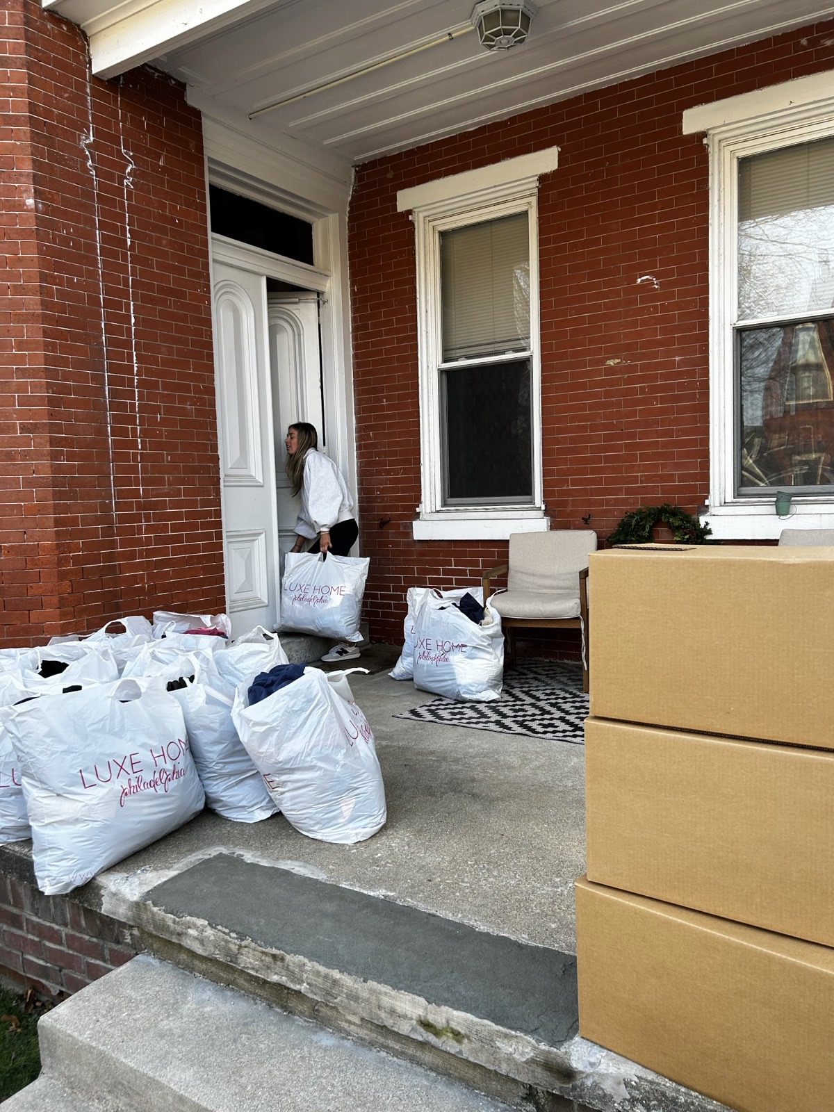Volunteer carrying donated clothes inside for sorting and distribution in Chester County PA
